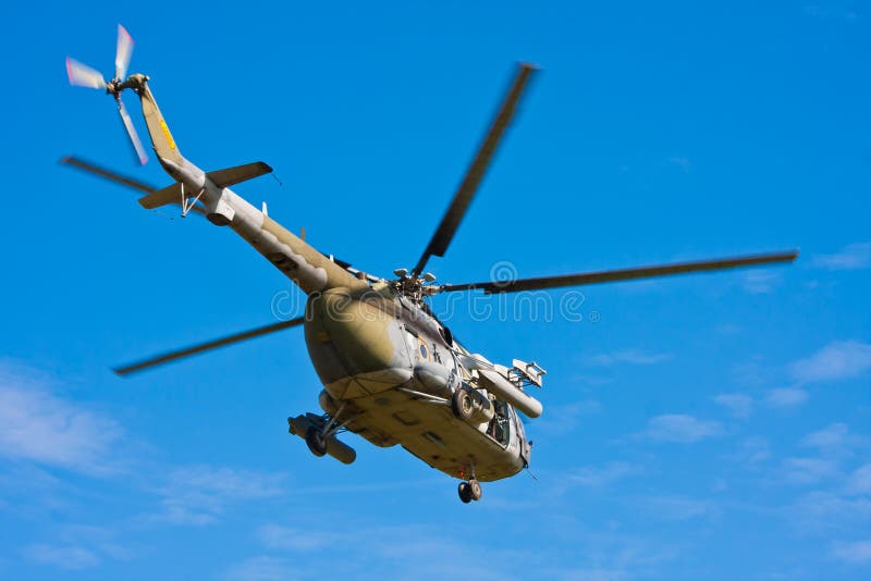 A photo of flying medium-size military helicopter. A photo of flying medium-size military helicopter