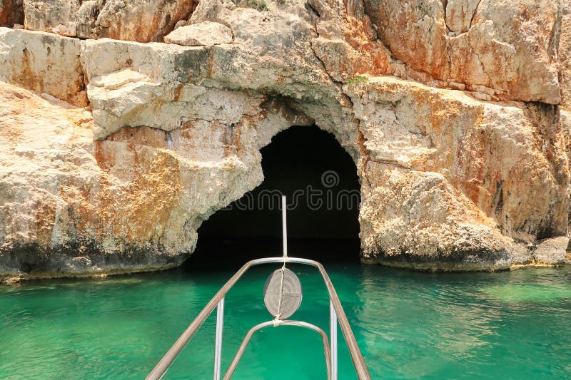 Approaching the famous Pirate Cave or Blue Cave on Asirli Island in the Gökkaya Bay on our Kekova Island boat trip, close to Demre, Turkey 2022. Approaching the famous Pirate Cave or Blue Cave on Asirli Island in the Gökkaya Bay on our Kekova Island boat trip, close to Demre, Turkey 2022