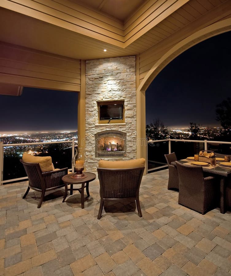 Luxurious outdoor patio at night with view of city lights. Luxurious outdoor patio at night with view of city lights