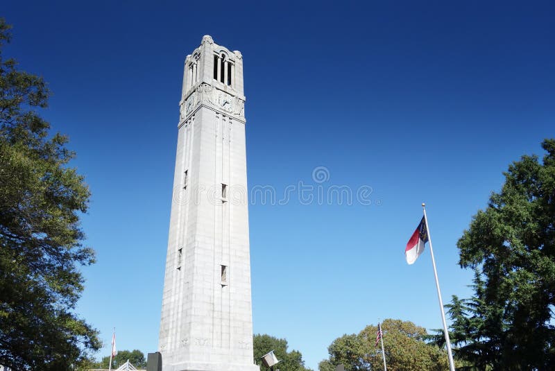 The belltower on the campus of NC State University in Raleigh North Carolina with the State flag. The belltower on the campus of NC State University in Raleigh North Carolina with the State flag