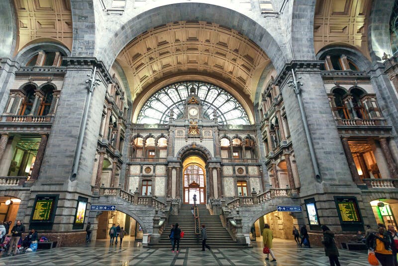 ANTWERP, BELGIUM - MAR 30: Many passengers inside the terminus building of railway station Antwerpen Centraal, constructed in 1905, on March 30, 2018. More than 1,200,000 people lives in Antwerp. ANTWERP, BELGIUM - MAR 30: Many passengers inside the terminus building of railway station Antwerpen Centraal, constructed in 1905, on March 30, 2018. More than 1,200,000 people lives in Antwerp