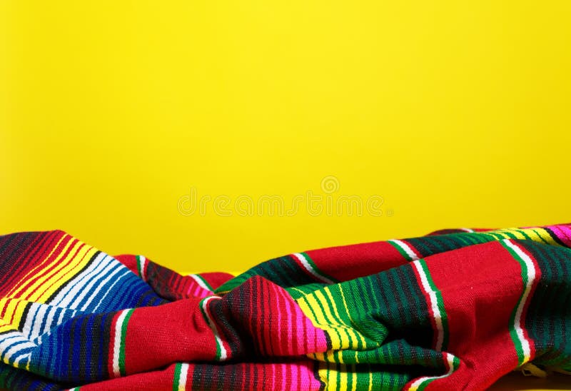 A colorful Mexican serape blanket on a yellow background. A colorful Mexican serape blanket on a yellow background