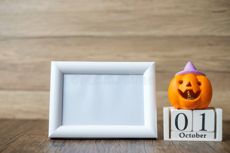 Orange pumpkin, 1 October calendar and frame with copy space for text. Happy Halloween day, Hello October, fall autumn season, Festive, party and holiday concept. Orange pumpkin, 1 October calendar and frame with copy space for text. Happy Halloween day, Hello October, fall autumn season, Festive, party and holiday concept