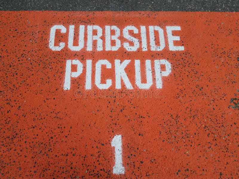 orange curbside pickup sign or letters on asphalt or ground with the number 1. orange curbside pickup sign or letters on asphalt or ground with the number 1