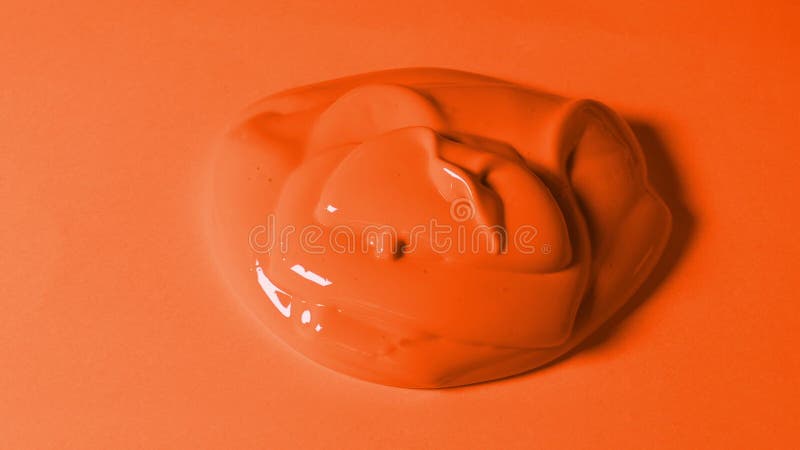 Πορτοκαλί χρώμα που χύνεται επάνω στην πορτοκαλιά επιφάνεια
