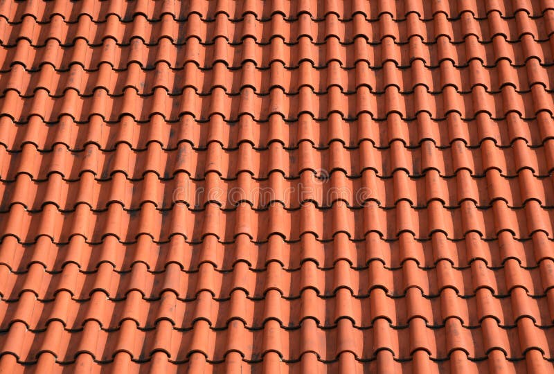 Clay based roof tiles, shingles background. Red - Orange round shaped shingles. Clay based roof tiles, shingles background. Red - Orange round shaped shingles.