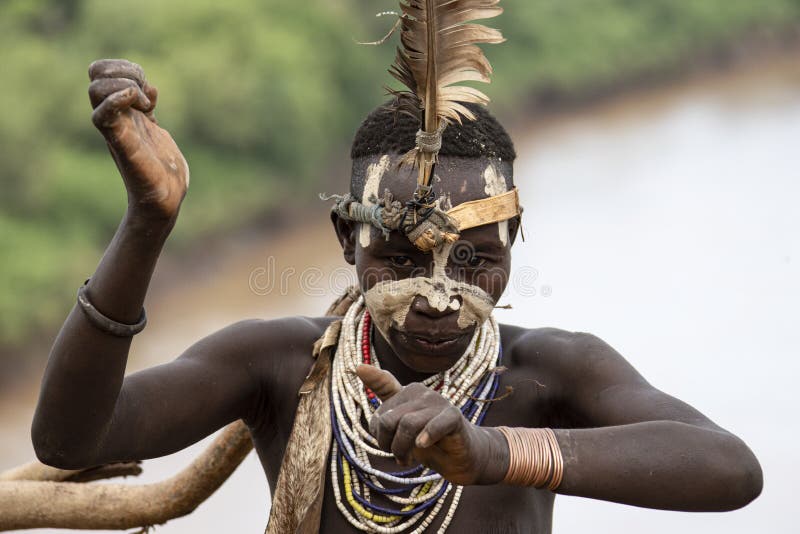 The Karo, or Kara, are a Nilotic ethnic group in Ethiopia famous for their body painting. They are also one of the smallest tribes in the region with an estimated population of 1.000-1.200 people. They are closely related to their neighbors, Hamer and Banna, with a lexical similarity of 81 They live along the east banks of the Omo River in southern Ethiopia and survive on agriculture and natural annual flooding. They have had the same culture and traditions for 500 years, like traditional dancing and painting their bodies with a mix of ash and fat or water.The Karo people differentiate themselves from many of the neighbouring tribes by excelling specifically in body and face painting. They paint themselves daily with coloured ochre, white chalk, yellow mineral rock, charcoal, and pulverized iron ore, all natural resources local to the area. The specific designs drawn on their bodies can change daily and vary in content, ranging from simple stars or lines to animal motifs, such as guinea fowl plumage, or to the most popular – a myriad of handprints covering the torso and legs. Both the Karo and the Hamar men use clay to construct elaborate hairstyles and headdresses for themselves, signifying status, beauty, and bravery.The photo is part of the album `SECOND ETHIOPIAN TRIBES EXPEDITION`. The Karo, or Kara, are a Nilotic ethnic group in Ethiopia famous for their body painting. They are also one of the smallest tribes in the region with an estimated population of 1.000-1.200 people. They are closely related to their neighbors, Hamer and Banna, with a lexical similarity of 81 They live along the east banks of the Omo River in southern Ethiopia and survive on agriculture and natural annual flooding. They have had the same culture and traditions for 500 years, like traditional dancing and painting their bodies with a mix of ash and fat or water.The Karo people differentiate themselves from many of the neighbouring tribes by excelling specifically in body and face painting. They paint themselves daily with coloured ochre, white chalk, yellow mineral rock, charcoal, and pulverized iron ore, all natural resources local to the area. The specific designs drawn on their bodies can change daily and vary in content, ranging from simple stars or lines to animal motifs, such as guinea fowl plumage, or to the most popular – a myriad of handprints covering the torso and legs. Both the Karo and the Hamar men use clay to construct elaborate hairstyles and headdresses for themselves, signifying status, beauty, and bravery.The photo is part of the album `SECOND ETHIOPIAN TRIBES EXPEDITION`