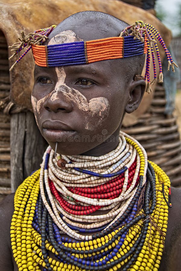 The Karo, or Kara, are a Nilotic ethnic group in Ethiopia famous for their body painting. They are also one of the smallest tribes in the region with an estimated population of 1.000-1.200 people. They are closely related to their neighbors, Hamer and Banna, with a lexical similarity of 81 They live along the east banks of the Omo River in southern Ethiopia and survive on agriculture and natural annual flooding. They have had the same culture and traditions for 500 years, like traditional dancing and painting their bodies with a mix of ash and fat or water.The Karo people differentiate themselves from many of the neighbouring tribes by excelling specifically in body and face painting. They paint themselves daily with coloured ochre, white chalk, yellow mineral rock, charcoal, and pulverized iron ore, all natural resources local to the area. The specific designs drawn on their bodies can change daily and vary in content, ranging from simple stars or lines to animal motifs, such as guinea fowl plumage, or to the most popular – a myriad of handprints covering the torso and legs. Both the Karo and the Hamar men use clay to construct elaborate hairstyles and headdresses for themselves, signifying status, beauty, and bravery.The photo is part of the album `SECOND ETHIOPIAN TRIBES EXPEDITION`. The Karo, or Kara, are a Nilotic ethnic group in Ethiopia famous for their body painting. They are also one of the smallest tribes in the region with an estimated population of 1.000-1.200 people. They are closely related to their neighbors, Hamer and Banna, with a lexical similarity of 81 They live along the east banks of the Omo River in southern Ethiopia and survive on agriculture and natural annual flooding. They have had the same culture and traditions for 500 years, like traditional dancing and painting their bodies with a mix of ash and fat or water.The Karo people differentiate themselves from many of the neighbouring tribes by excelling specifically in body and face painting. They paint themselves daily with coloured ochre, white chalk, yellow mineral rock, charcoal, and pulverized iron ore, all natural resources local to the area. The specific designs drawn on their bodies can change daily and vary in content, ranging from simple stars or lines to animal motifs, such as guinea fowl plumage, or to the most popular – a myriad of handprints covering the torso and legs. Both the Karo and the Hamar men use clay to construct elaborate hairstyles and headdresses for themselves, signifying status, beauty, and bravery.The photo is part of the album `SECOND ETHIOPIAN TRIBES EXPEDITION`