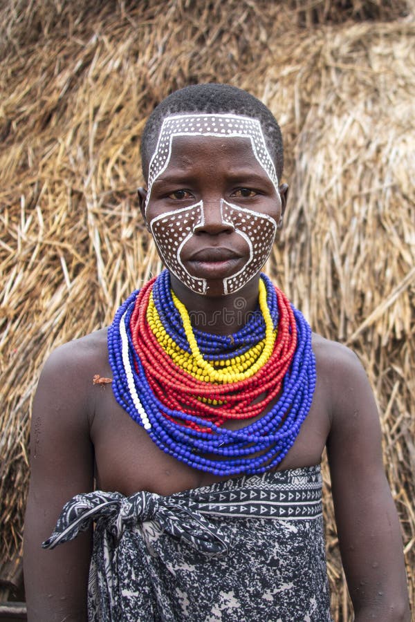 The Karo, or Kara, are a Nilotic ethnic group in Ethiopia famous for their body painting. They are also one of the smallest tribes in the region with an estimated population of 1.000-1.200 people. They are closely related to their neighbors, Hamer and Banna, with a lexical similarity of 81 They live along the east banks of the Omo River in southern Ethiopia and survive on agriculture and natural annual flooding. They have had the same culture and traditions for 500 years, like traditional dancing and painting their bodies with a mix of ash and fat or water.The Karo people differentiate themselves from many of the neighbouring tribes by excelling specifically in body and face painting. They paint themselves daily with coloured ochre, white chalk, yellow mineral rock, charcoal, and pulverized iron ore, all natural resources local to the area. The specific designs drawn on their bodies can change daily and vary in content, ranging from simple stars or lines to animal motifs, such as guinea fowl plumage, or to the most popular – a myriad of handprints covering the torso and legs. Both the Karo and the Hamar men use clay to construct elaborate hairstyles and headdresses for themselves, signifying status, beauty, and bravery.The photo is part of the album `SECOND ETHIOPIAN TRIBES EXPEDITION`. The Karo, or Kara, are a Nilotic ethnic group in Ethiopia famous for their body painting. They are also one of the smallest tribes in the region with an estimated population of 1.000-1.200 people. They are closely related to their neighbors, Hamer and Banna, with a lexical similarity of 81 They live along the east banks of the Omo River in southern Ethiopia and survive on agriculture and natural annual flooding. They have had the same culture and traditions for 500 years, like traditional dancing and painting their bodies with a mix of ash and fat or water.The Karo people differentiate themselves from many of the neighbouring tribes by excelling specifically in body and face painting. They paint themselves daily with coloured ochre, white chalk, yellow mineral rock, charcoal, and pulverized iron ore, all natural resources local to the area. The specific designs drawn on their bodies can change daily and vary in content, ranging from simple stars or lines to animal motifs, such as guinea fowl plumage, or to the most popular – a myriad of handprints covering the torso and legs. Both the Karo and the Hamar men use clay to construct elaborate hairstyles and headdresses for themselves, signifying status, beauty, and bravery.The photo is part of the album `SECOND ETHIOPIAN TRIBES EXPEDITION`