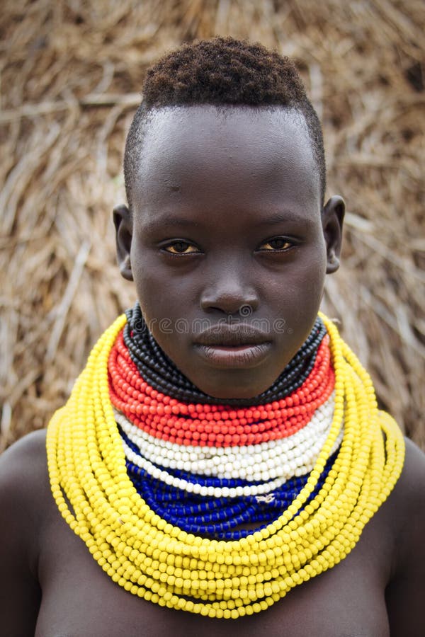 The Karo, or Kara, are a Nilotic ethnic group in Ethiopia famous for their body painting. They are also one of the smallest tribes in the region with an estimated population of 1.000-1.200 people. They are closely related to their neighbors, Hamer and Banna, with a lexical similarity of 81 They live along the east banks of the Omo River in southern Ethiopia and survive on agriculture and natural annual flooding. They have had the same culture and traditions for 500 years, like traditional dancing and painting their bodies with a mix of ash and fat or water.The Karo people differentiate themselves from many of the neighbouring tribes by excelling specifically in body and face painting. They paint themselves daily with coloured ochre, white chalk, yellow mineral rock, charcoal, and pulverized iron ore, all natural resources local to the area. The specific designs drawn on their bodies can change daily and vary in content, ranging from simple stars or lines to animal motifs, such as guinea fowl plumage, or to the most popular – a myriad of handprints covering the torso and legs. Both the Karo and the Hamar men use clay to construct elaborate hairstyles and headdresses for themselves, signifying status, beauty, and bravery.The photo is part of the album `SECOND ETHIOPIAN TRIBES EXPEDITION`. The Karo, or Kara, are a Nilotic ethnic group in Ethiopia famous for their body painting. They are also one of the smallest tribes in the region with an estimated population of 1.000-1.200 people. They are closely related to their neighbors, Hamer and Banna, with a lexical similarity of 81 They live along the east banks of the Omo River in southern Ethiopia and survive on agriculture and natural annual flooding. They have had the same culture and traditions for 500 years, like traditional dancing and painting their bodies with a mix of ash and fat or water.The Karo people differentiate themselves from many of the neighbouring tribes by excelling specifically in body and face painting. They paint themselves daily with coloured ochre, white chalk, yellow mineral rock, charcoal, and pulverized iron ore, all natural resources local to the area. The specific designs drawn on their bodies can change daily and vary in content, ranging from simple stars or lines to animal motifs, such as guinea fowl plumage, or to the most popular – a myriad of handprints covering the torso and legs. Both the Karo and the Hamar men use clay to construct elaborate hairstyles and headdresses for themselves, signifying status, beauty, and bravery.The photo is part of the album `SECOND ETHIOPIAN TRIBES EXPEDITION`