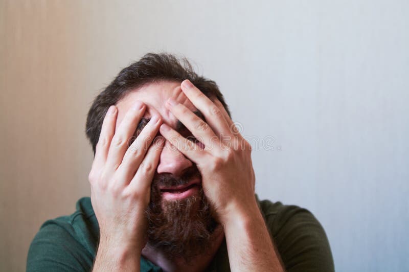 πορτρέτο ενός νεαρού με σκούρο μούσι με διάφορα συναισθήματα στο πρόσωπό του με πράσινο πουκάμισο. στοκ φωτογραφίες