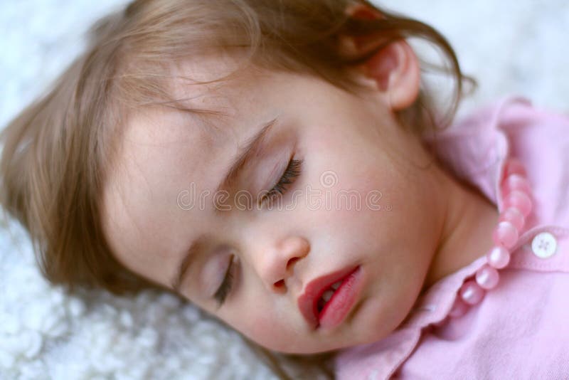 Cute, multi-racial, 2 year old girl wears a pink top and pink pearls as she sleeps. Little girl is Asian/Caucasian with brown hair and eyes. She has long eyelashes and pretty pink lips. Cute, multi-racial, 2 year old girl wears a pink top and pink pearls as she sleeps. Little girl is Asian/Caucasian with brown hair and eyes. She has long eyelashes and pretty pink lips.