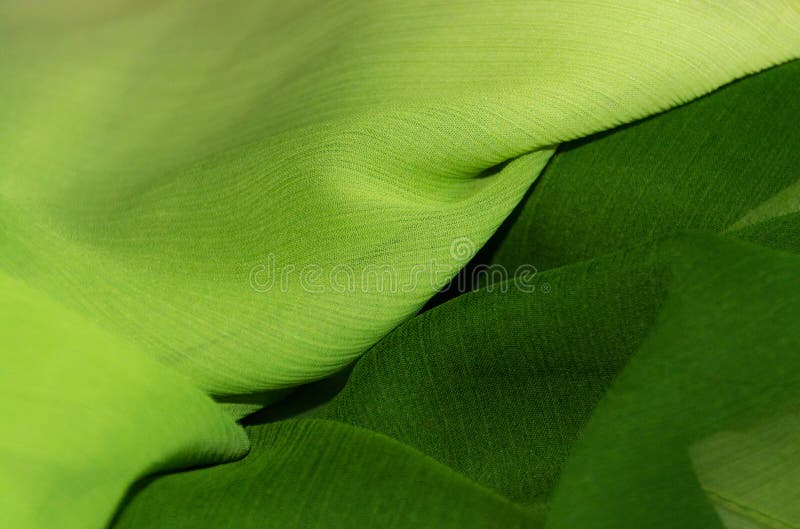 Chiffon fabric in two shades of green, diagonally arranged. Chiffon fabric in two shades of green, diagonally arranged