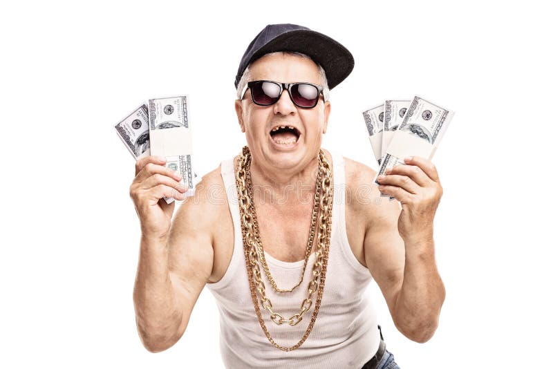 Delighted senior in hip hop outfit holding a few stacks of money and looking at the camera isolated on white background. Delighted senior in hip hop outfit holding a few stacks of money and looking at the camera isolated on white background