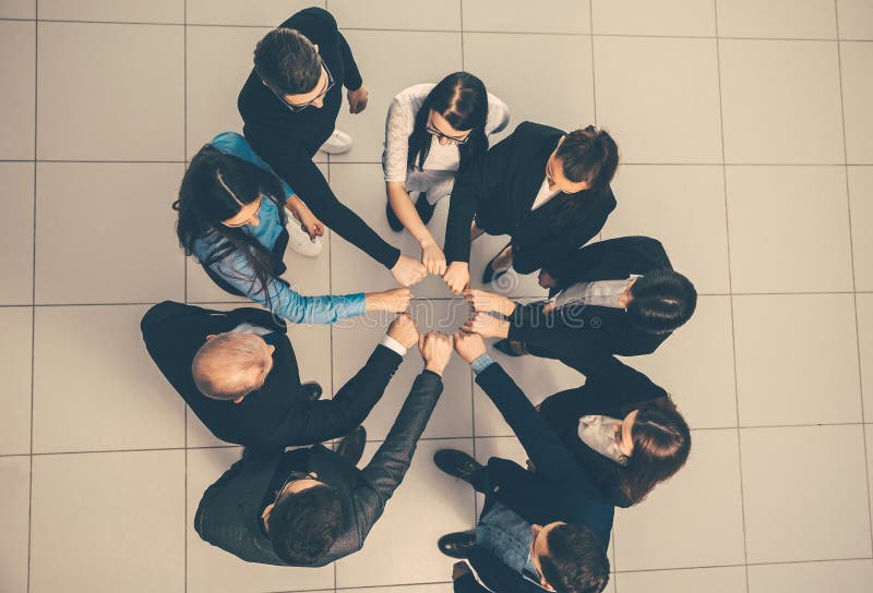 Top view. group of young professionals standing in a circle. the concept of teamwork. Top view. group of young professionals standing in a circle. the concept of teamwork