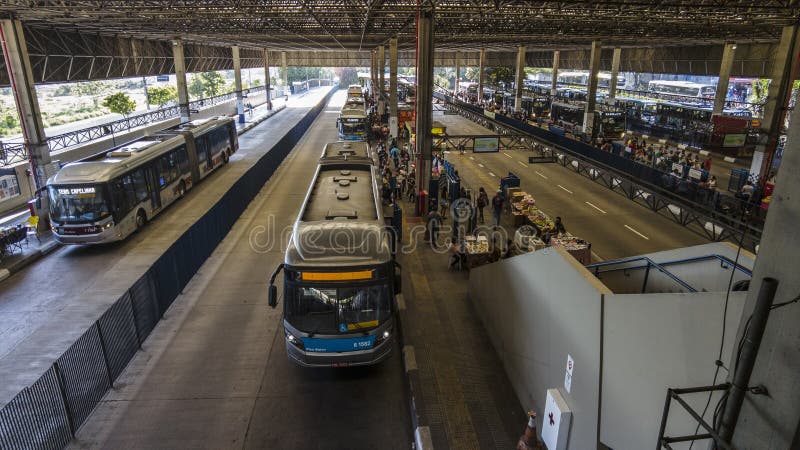 Sao Paulo, Brazil, November 22, 2021. View of people waiting and traffic to urban buses in Santo Amaro Bus Terminal, Sao Paulo, Brazil. Sao Paulo, Brazil, November 22, 2021. View of people waiting and traffic to urban buses in Santo Amaro Bus Terminal, Sao Paulo, Brazil