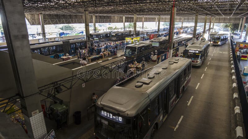 Sao Paulo, Brazil, November 22, 2021. View of people waiting and traffic to urban buses in Santo Amaro Bus Terminal, Sao Paulo, Brazil. Sao Paulo, Brazil, November 22, 2021. View of people waiting and traffic to urban buses in Santo Amaro Bus Terminal, Sao Paulo, Brazil