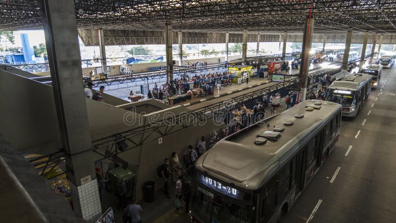 Sao Paulo, Brazil, November 22, 2021. View of people waiting and traffic to urban buses in Santo Amaro Bus Terminal, Sao Paulo, Brazil. Sao Paulo, Brazil, November 22, 2021. View of people waiting and traffic to urban buses in Santo Amaro Bus Terminal, Sao Paulo, Brazil