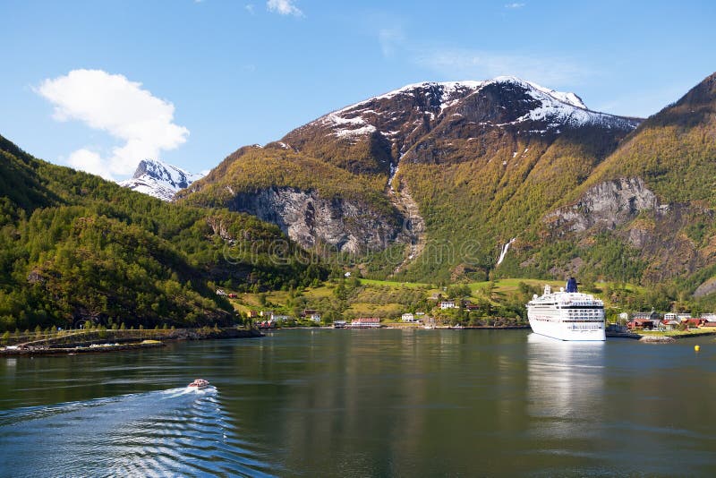 A tender from a cruise ship approaches the Norwegian town of Flam on the Aurlandsfjord. A tender from a cruise ship approaches the Norwegian town of Flam on the Aurlandsfjord.