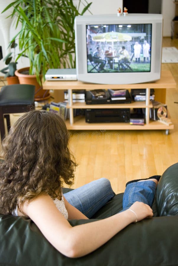 A girl sitting and watching tv. A girl sitting and watching tv.