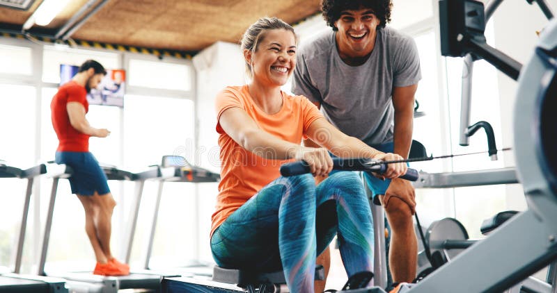 Personal trainer helping women reach goals in gym. Personal trainer helping women reach goals in gym