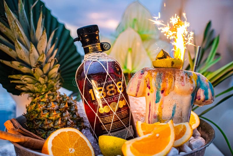 promotional shot of rum bowl with ice palm leaves pineapple orange fireworks. promotional shot of rum bowl with ice palm leaves pineapple orange fireworks.