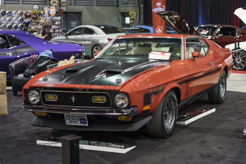 Front side view of red 1971 ford mustang boss 351 in display at the international show car association 2015. Isca show car 2015 at quebec, canada. Front side view of red 1971 ford mustang boss 351 in display at the international show car association 2015. Isca show car 2015 at quebec, canada.