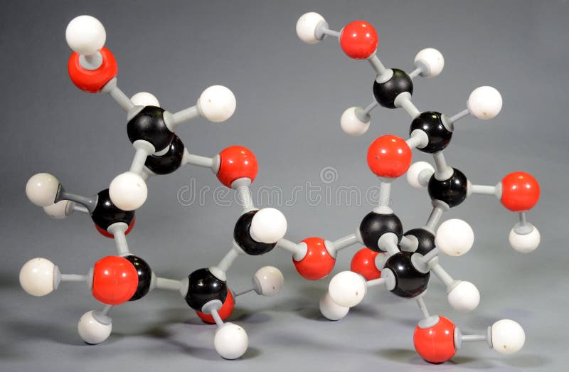 Molecule model of sugar C12H22O11. Red is oxygen, black is carbon, and white is hydrogen. Molecule model of sugar C12H22O11. Red is oxygen, black is carbon, and white is hydrogen