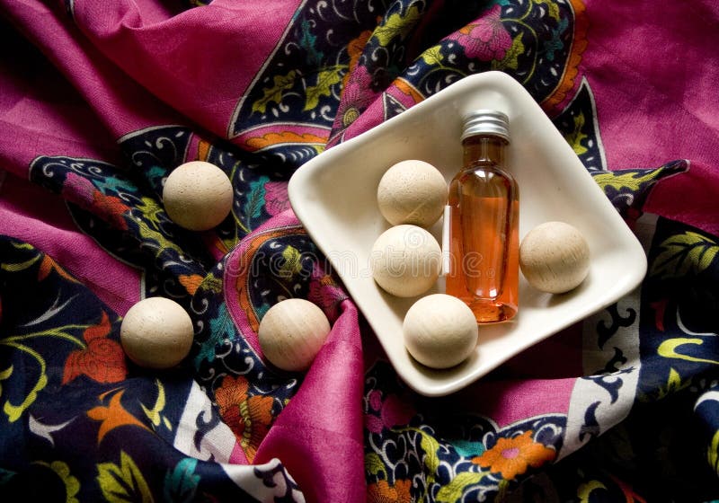 Aromateraphy oil, wooden bolls and pattern fabric. Aromateraphy oil, wooden bolls and pattern fabric