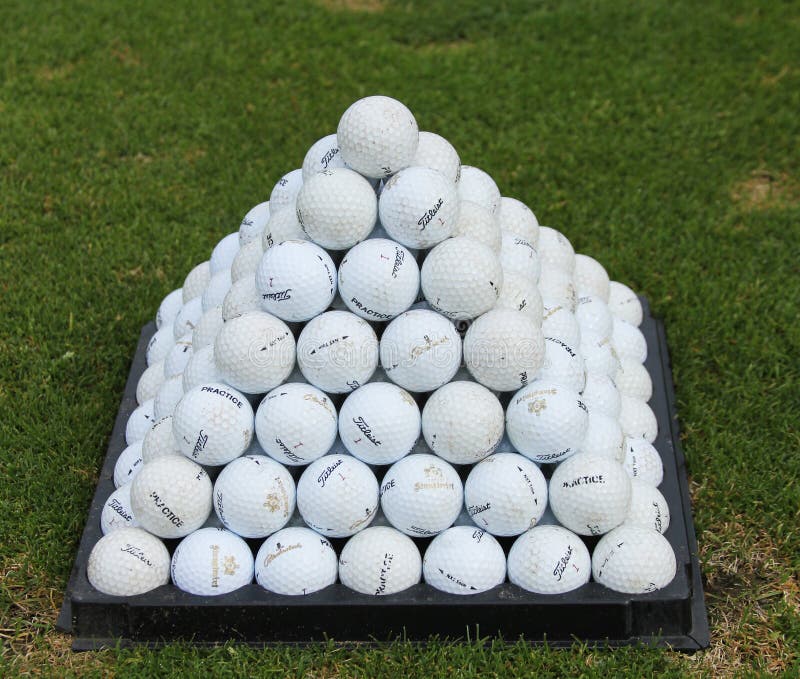Golf balls pyramid on the driving range. Titleist brand is The #1 ball in golf. Golf balls pyramid on the driving range. Titleist brand is The #1 ball in golf.