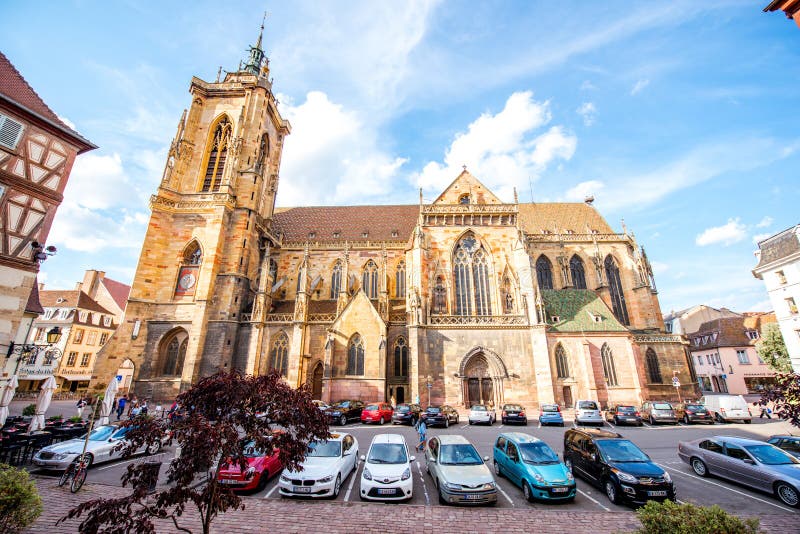 COLMAR, FRANCE - July 26, 2017: View on the saint Martins cathedral in the center of Colmar town during the sunny weather in Alsace region, France. COLMAR, FRANCE - July 26, 2017: View on the saint Martins cathedral in the center of Colmar town during the sunny weather in Alsace region, France