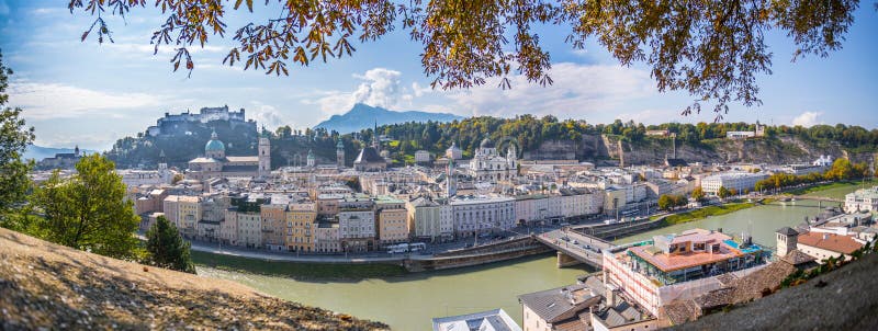 Panorama of Salzburg historic district at autumn time, colorful leaves and colors with sunshine, Austria, magic, alps, city, landscape, austrian, castle, fall, sightseeing, old, postcard, idyll, day, building, september, cathedral, sunbeam, baroque, october, church, medieval, europe, fortress, holiday, trip, rooftop, landmark, sunlight, beautiful, skyline, tourism, town, travel, unesco, vacation, view, hohensalzburg, salzach. Panorama of Salzburg historic district at autumn time, colorful leaves and colors with sunshine, Austria, magic, alps, city, landscape, austrian, castle, fall, sightseeing, old, postcard, idyll, day, building, september, cathedral, sunbeam, baroque, october, church, medieval, europe, fortress, holiday, trip, rooftop, landmark, sunlight, beautiful, skyline, tourism, town, travel, unesco, vacation, view, hohensalzburg, salzach