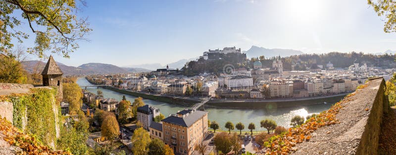 Panorama of Salzburg historic district at autumn time, colorful leaves and colors with sunshine, Austria, magic, alps, city, landscape, austrian, castle, fall, sightseeing, old, postcard, idyll, day, building, september, cathedral, sunbeam, baroque, october, church, medieval, europe, fortress, holiday, trip, rooftop, landmark, sunlight, beautiful, skyline, tourism, town, travel, unesco, vacation, view, hohensalzburg, salzach. Panorama of Salzburg historic district at autumn time, colorful leaves and colors with sunshine, Austria, magic, alps, city, landscape, austrian, castle, fall, sightseeing, old, postcard, idyll, day, building, september, cathedral, sunbeam, baroque, october, church, medieval, europe, fortress, holiday, trip, rooftop, landmark, sunlight, beautiful, skyline, tourism, town, travel, unesco, vacation, view, hohensalzburg, salzach