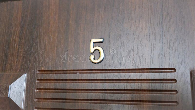 Apartment doors at number five. High quality photo. Apartment doors at number five. High quality photo