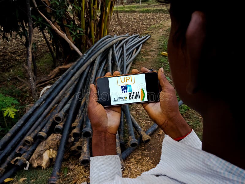 UPI paytm BHIM application payment gateway displayed on mobile phone screen by indian villager in India Dec 2019. UPI paytm BHIM application payment gateway displayed on mobile phone screen by indian villager in India Dec 2019