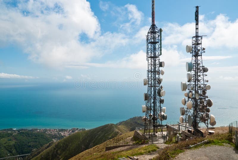 Panorama with two telecommunications towers against sea and sky. Panorama with two telecommunications towers against sea and sky