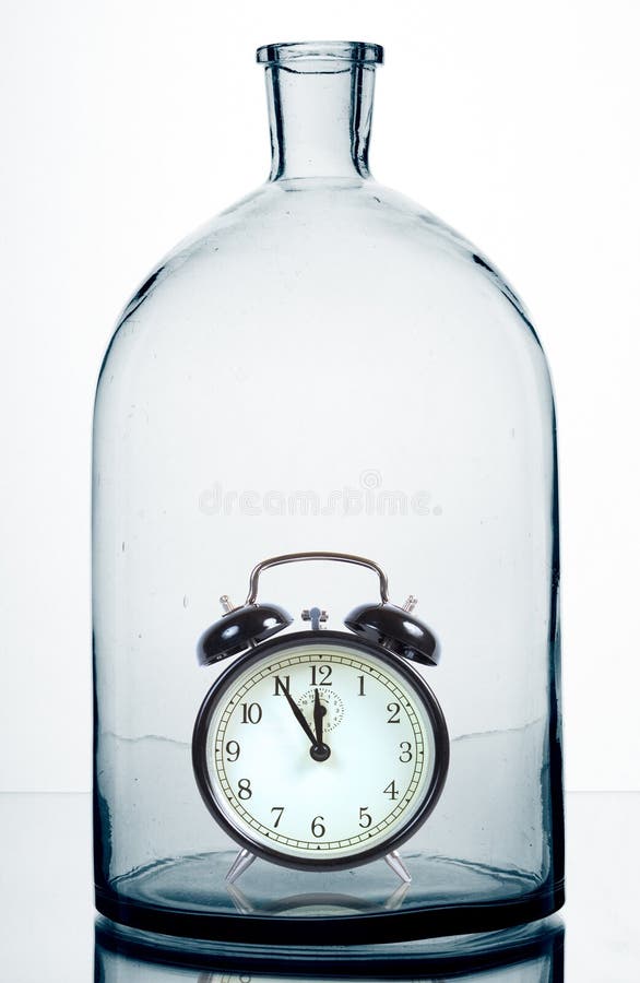 Alarm clock inside an old glass bottle. Alarm clock inside an old glass bottle.