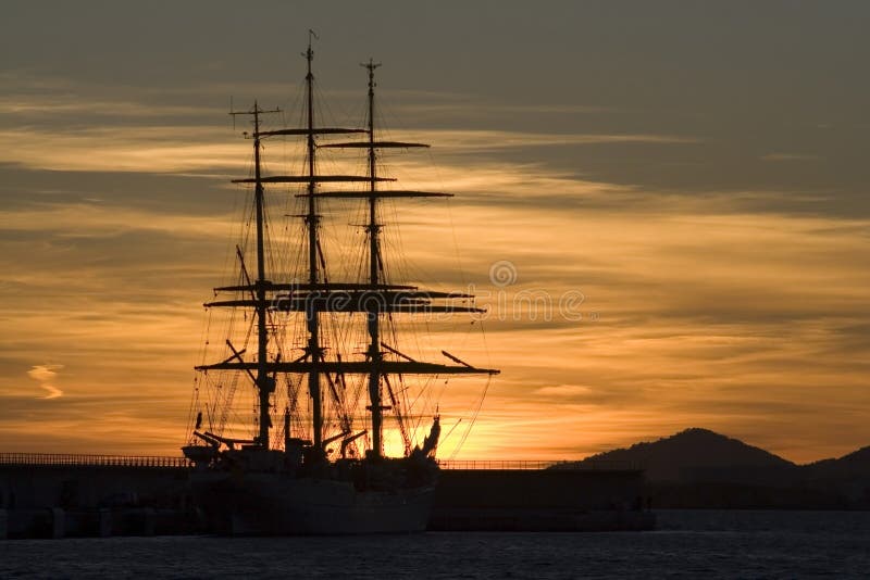 Sailboat sillouette under a golden sunset. Holiday island Ibiza. Sailboat sillouette under a golden sunset. Holiday island Ibiza.