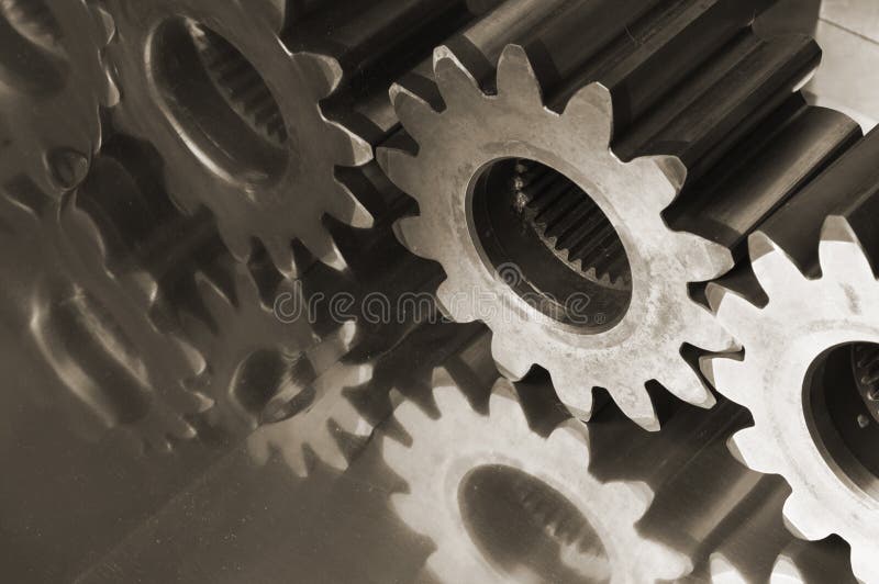 Gears,cogs in brownish connecting against titanium. Gears,cogs in brownish connecting against titanium