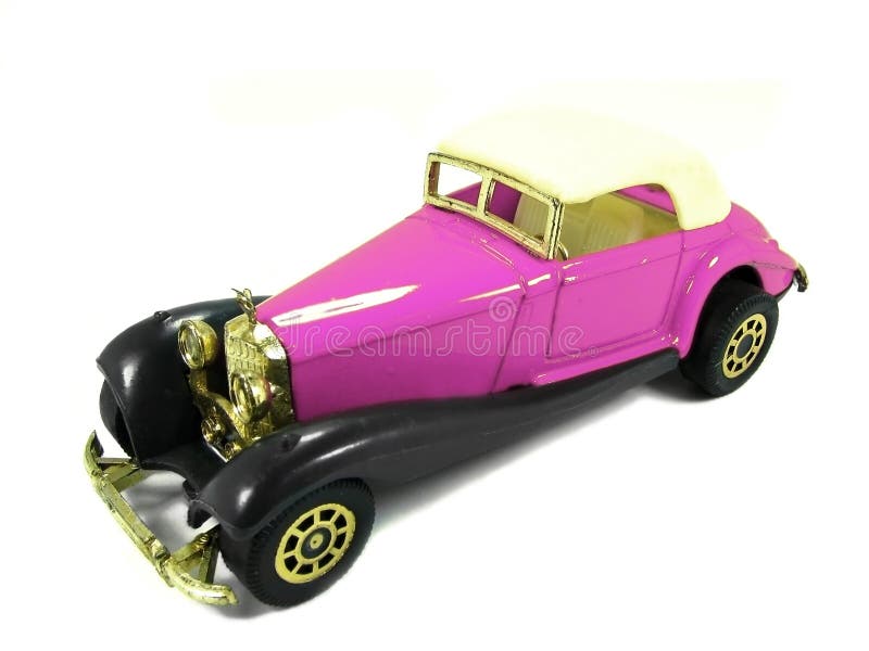 An isolated pink and classic toy car. An isolated pink and classic toy car.