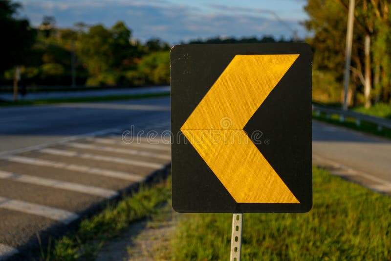 traffic sign - traffic sign to align in the shape of an arrow - yellow symbol on black background. traffic sign - traffic sign to align in the shape of an arrow - yellow symbol on black background
