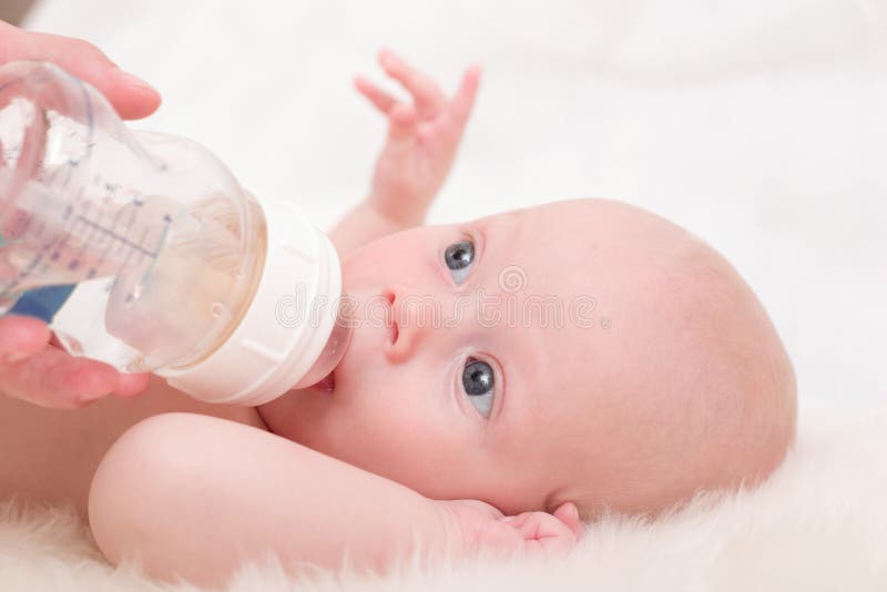 Little cute baby - 3-month boy - feeding with bottle. Little cute baby - 3-month boy - feeding with bottle