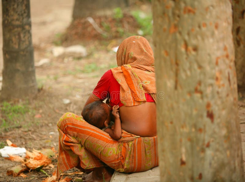 Mother feeds her baby on the street,Life in Dhaka city,Bangladesh. Mother feeds her baby on the street,Life in Dhaka city,Bangladesh