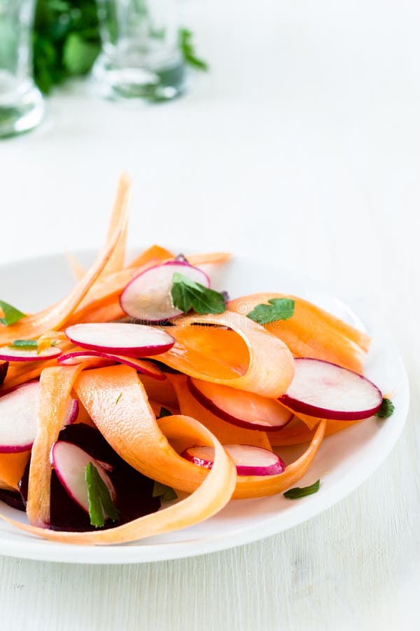 Healthy beet carrot radish salad on white plate. Healthy beet carrot radish salad on white plate