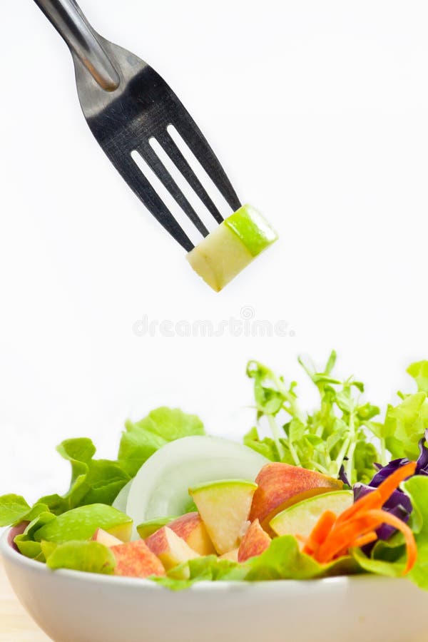 Apple Salad with pieces of green apple on fork. Apple Salad with pieces of green apple on fork