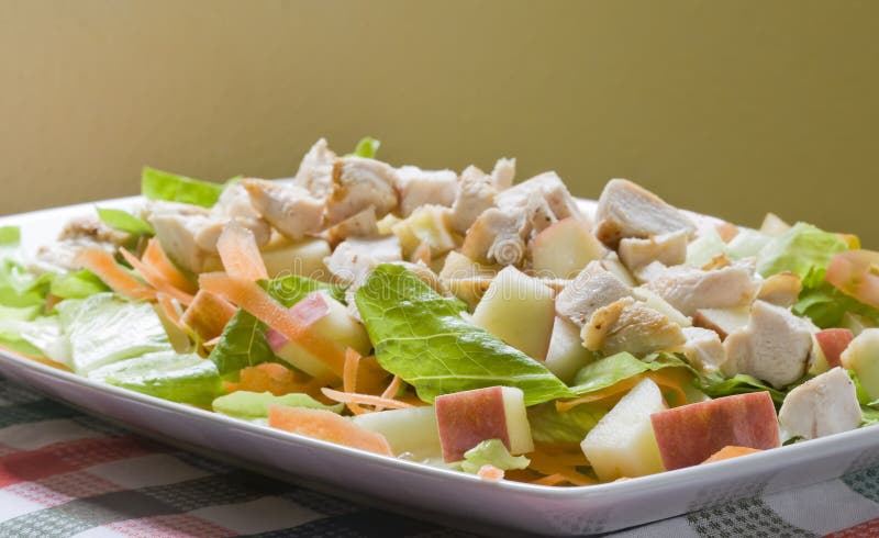 A healthy fast food salad with apple and grilled chicken. A healthy fast food salad with apple and grilled chicken