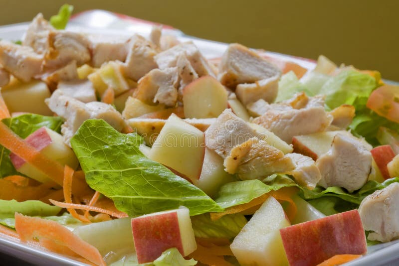 A healthy fast food salad with apple and grilled chicken. A healthy fast food salad with apple and grilled chicken
