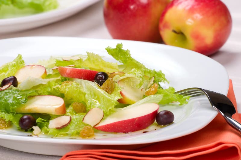 Fall salad with apples, almonds, raisins and black olives served for healthy lunch. Fall salad with apples, almonds, raisins and black olives served for healthy lunch