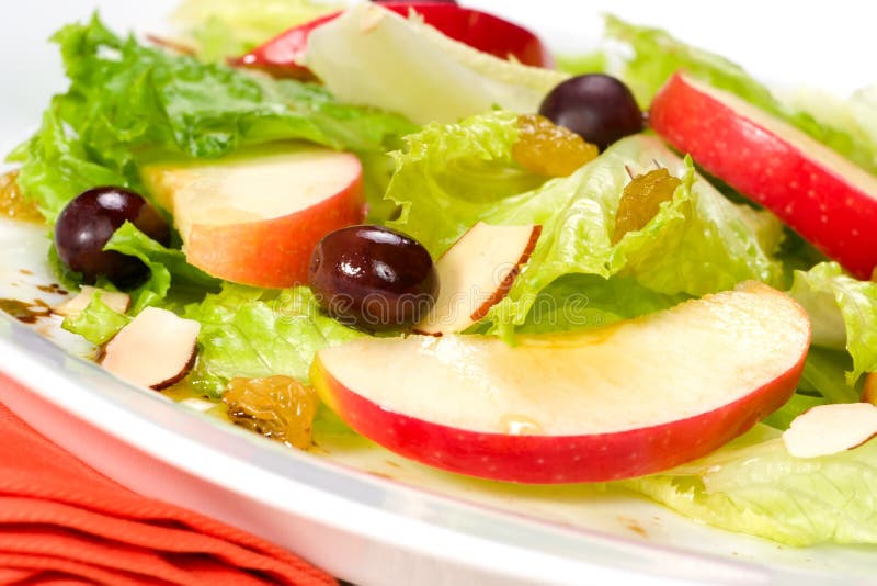 Spring salad with apples, almonds, raisins and black olives served for healthy lunch. Spring salad with apples, almonds, raisins and black olives served for healthy lunch