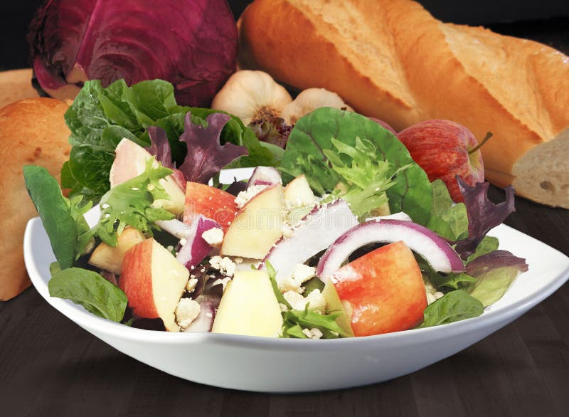 Apple Salad with background in white bowl with lettuce onion blue cheese feta mixed greens. Apple Salad with background in white bowl with lettuce onion blue cheese feta mixed greens